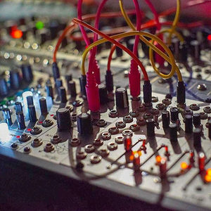 Close-up of colourful patch cables connecting Eurorack modular synthesizer panels in the Zombie Nation