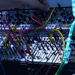 Close-up of a Zombie Nation studio modular synthesizer panel densely patched with colourful patch cables