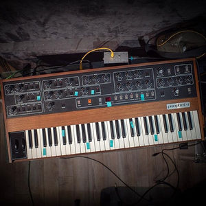 A Sequential Prophet-5 polyphonic synthesizer with wood side panels resting in the Zombie Nation studio