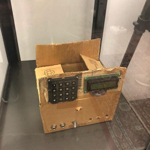 Handmade cardboard box prototype of the SIDstation with a numeric keypad and LCD display, bolted together