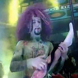 Zombie Nation on BBC Top of the Pops in zombie costume with purple wig and body paint, green stage smoke