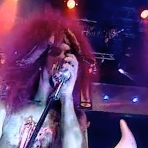 Zombie Nation zombie costume close-up at the microphone on BBC Top of the Pops under dramatic stage lights