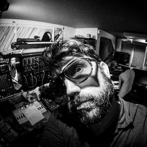 Black and white fisheye selfie in the Zombie Nation studio, tilted close-up with large glasses and gear