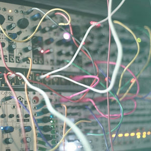 Zombie Nation Eurorack modular synthesizer close-up with tangled white, pink and yellow patch cables, soft