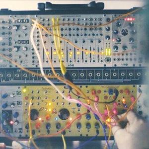 Zombie Nation Eurorack modular with WMD Performance Mixer, colorful patch cables, hand reaching from the