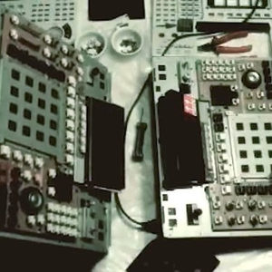 Film still showing two technicians in white lab coats opening Akai MPC samplers, Zombie Nation video