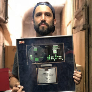 Florian Senfter holding the UK silver award for Kernkraft 400 by Zombie Nation, framed disc with BPI plaque