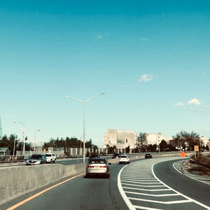 View from the passenger seat on an American highway, Zombie Nation on tour, blue sky and highway signs