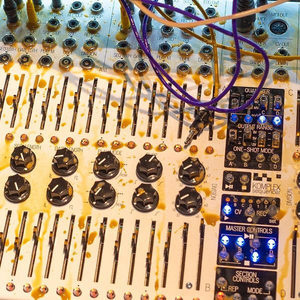 Zombie Nation modular synthesizer fader bank with coffee stains on the panel and a purple patch cable