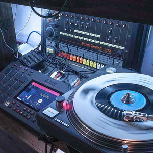 Overhead shot of the Zombie Nation setup with an Akai MPC Live, turntable with vinyl and a Roland drum