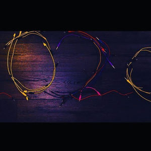 Colorful Eurorack patch cables arranged on a dark wooden floor to spell 2020, Zombie Nation New Year
