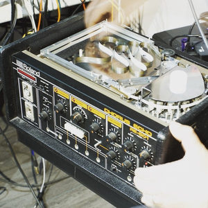 Reel-to-reel tape machine in the Zombie Nation studio with tape being threaded, colorful cables visible