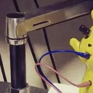 Roland DG Compu Music with a Pikachu toy, Pocket MIDI Thru and patch cables on a studio desk