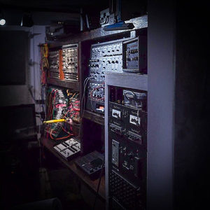 Zombie Nation studio gear rack viewed from the side, modular synthesizers in wood frames, 19-inch outboard