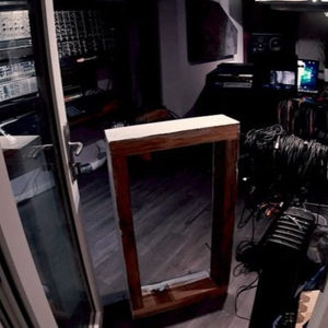 Zombie Nation studio shelving frame under construction, large timber beams assembled by hand, fisheye view