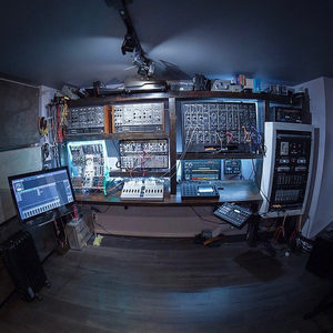 Zombie Nation studio overview: custom wood modular rack, multiple synths, DAW screen left, turntable right